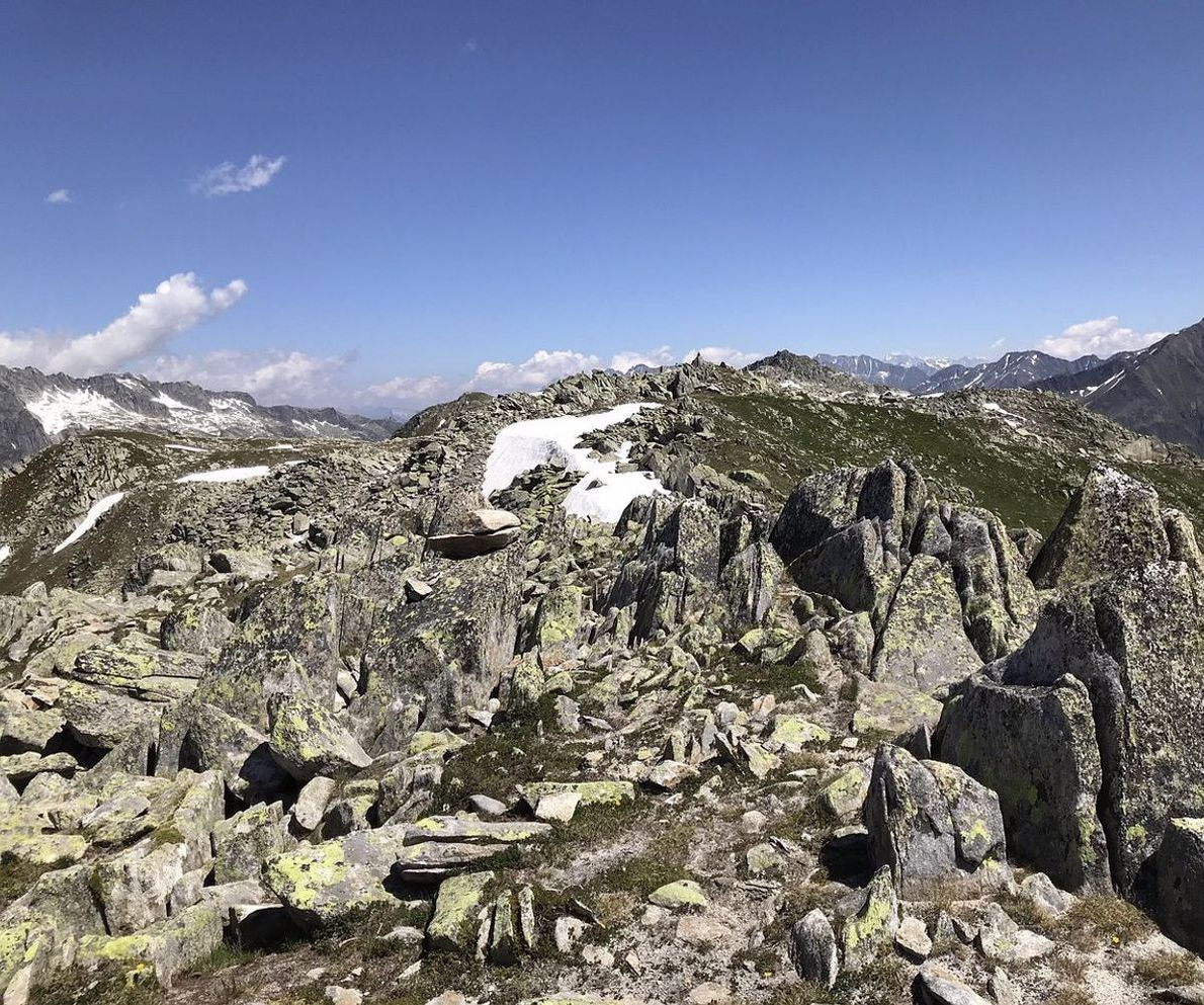 Hiker's boots on rocky alpine terrain during a thunderstorm